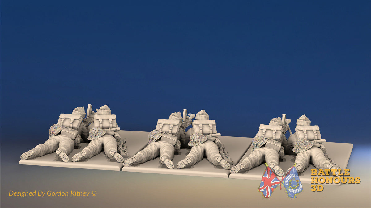 WW2 British Commando Bren gun teams in cap comforters firing prone, rear view